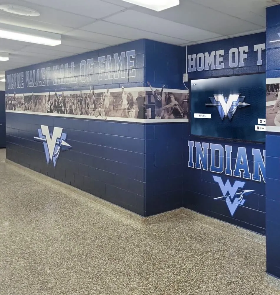 School athletic hallway featuring hall of fame recognition wall with Wayne Valley Indians branding Wayne Valley High School hall of fame athletic hallway with Indians logo and recognition boards